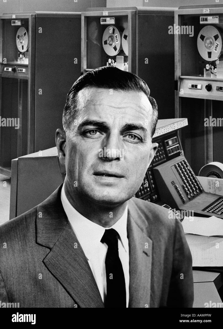 1960s BUSINESSMAN PORTRAIT SUPERIMPOSED ON BACKGROUND OF LARGE COMPUTER SYSTEM Stock Photo