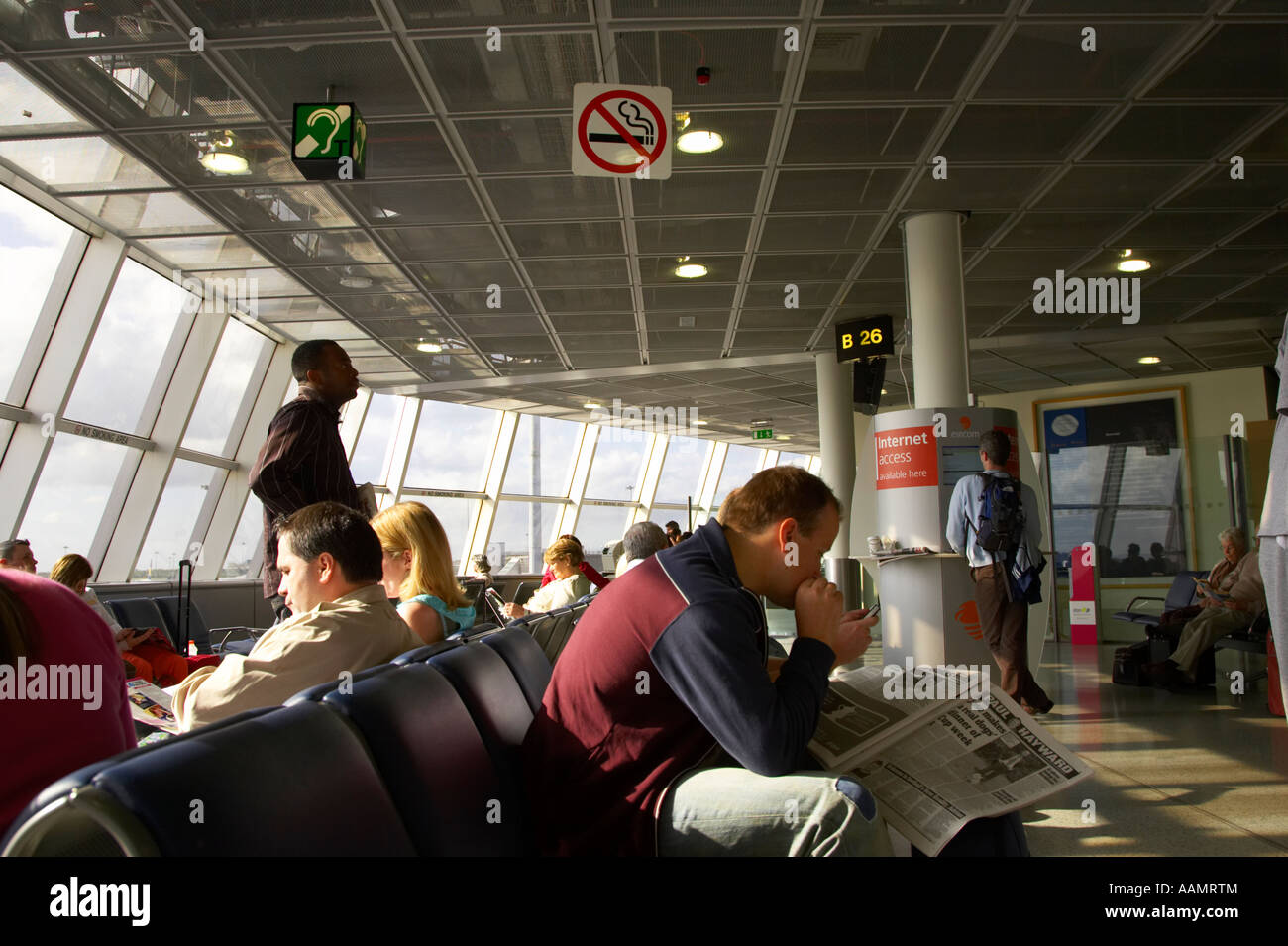 passengers sitting in no smoking departure area of dublin international airport ireland Stock Photo