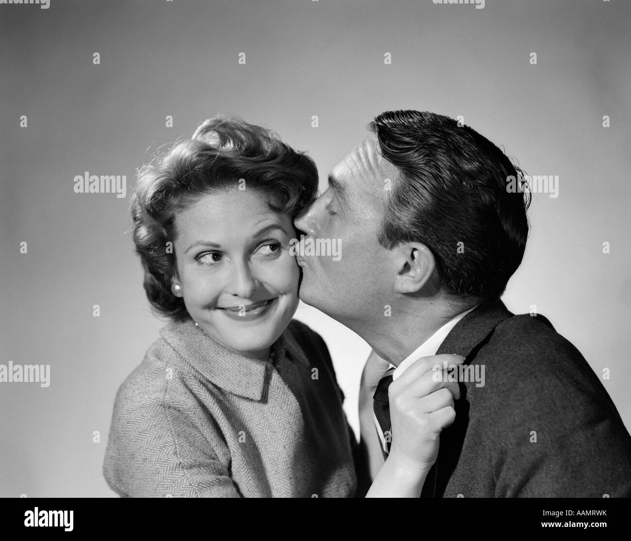 Kiss man woman cheek Black and White Stock Photos & Images - Alamy