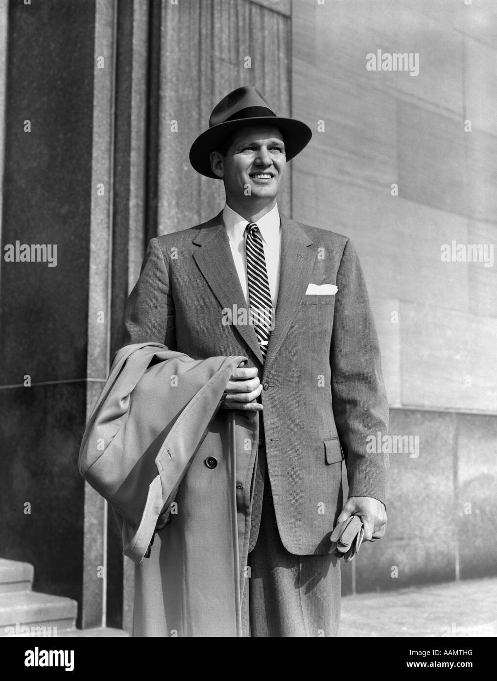 1950s MAN IN SUIT STRIPED TIE WEARING HAT HOLDING COAT OVER ARM GLOVES ...