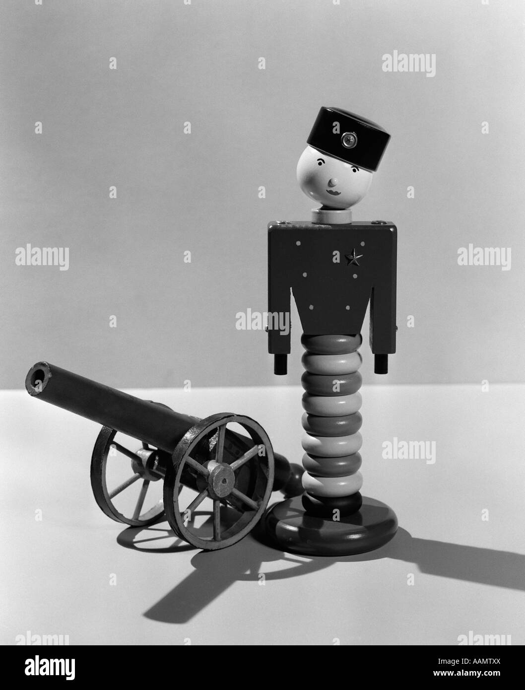 1930s WOODEN TOY SOLDIER NEXT TO CANNON Stock Photo