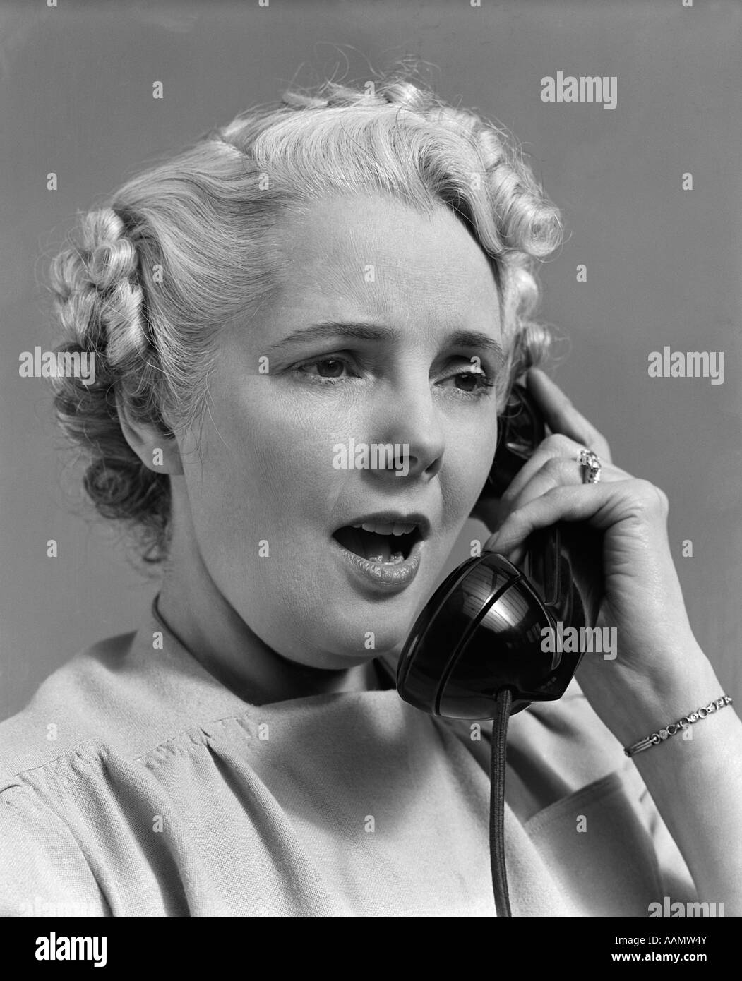 1930s 1940s WOMAN TALKING ON TELEPHONE Stock Photo
