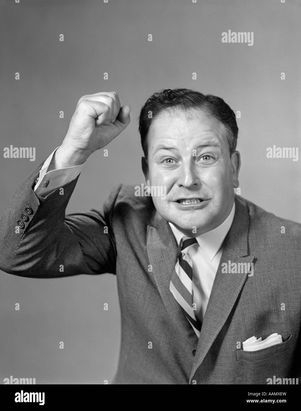1950s EXCITED ANGRY BUSINESSMAN RAISING HIS FIST Stock Photo