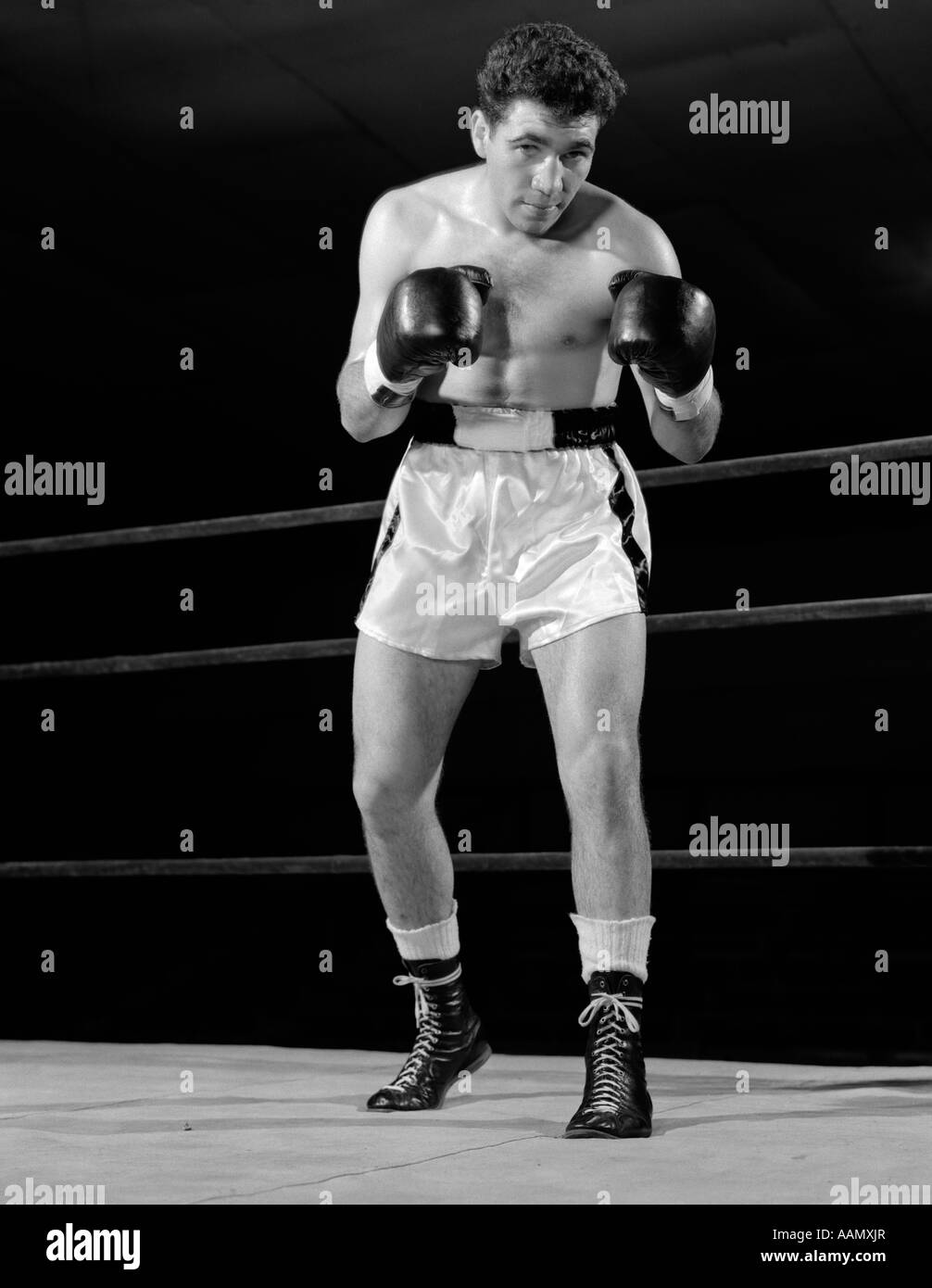 1950s FULL FIGURE BOXER IN RING FACING CAMERA WITH FISTS IN BOXING GLOVES  Stock Photo - Alamy
