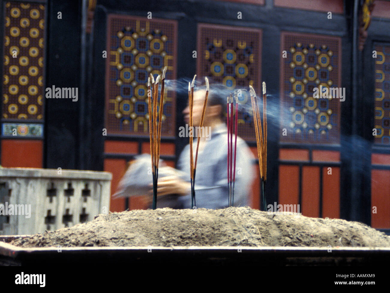 Buddhist worshipper burning incense sticks hi-res stock photography and ...