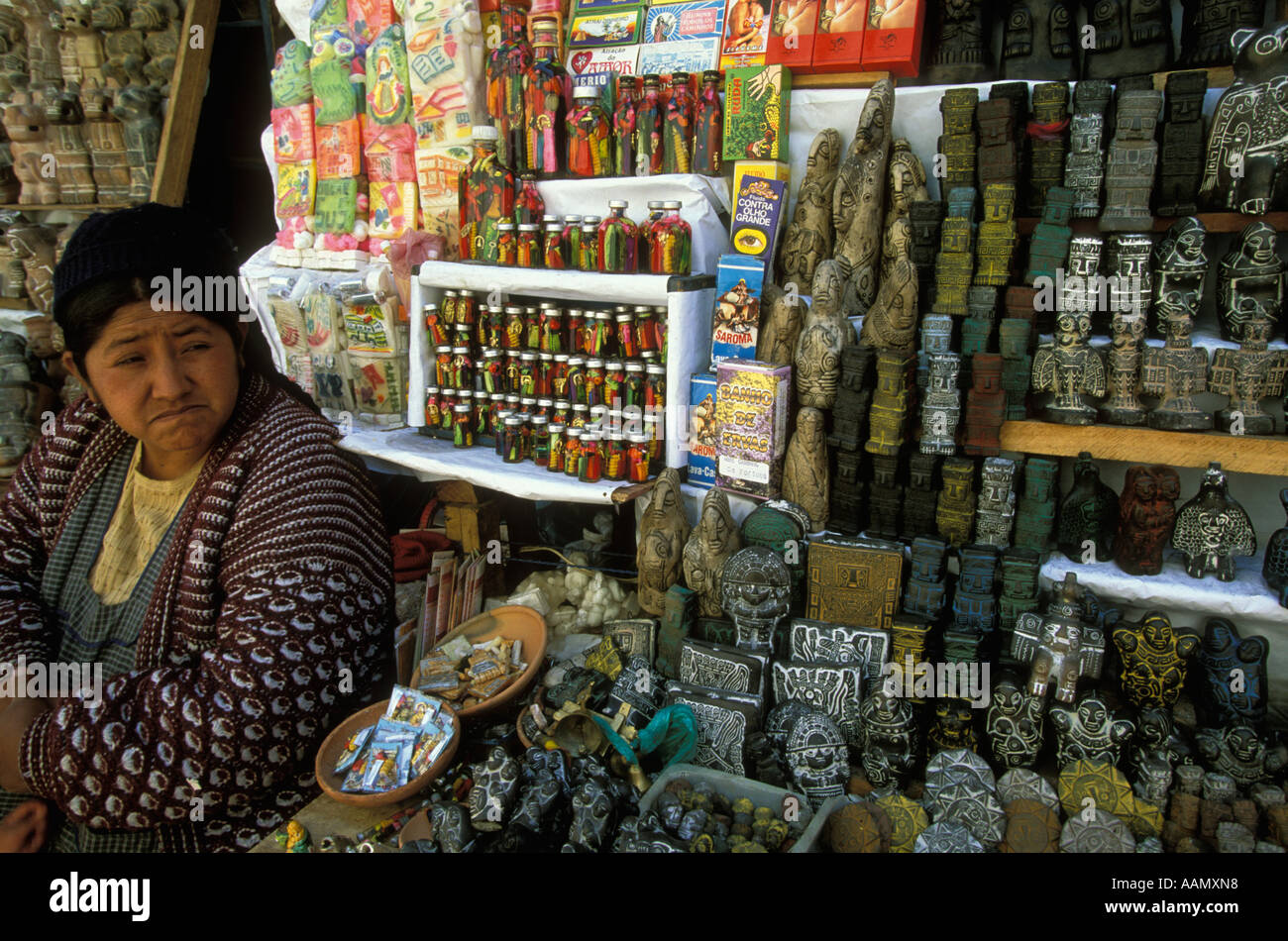 A street vendor at Witches Market in La Paz  Bolivia sells a variety of statuettes medicinal  herbs and magic objects Stock Photo