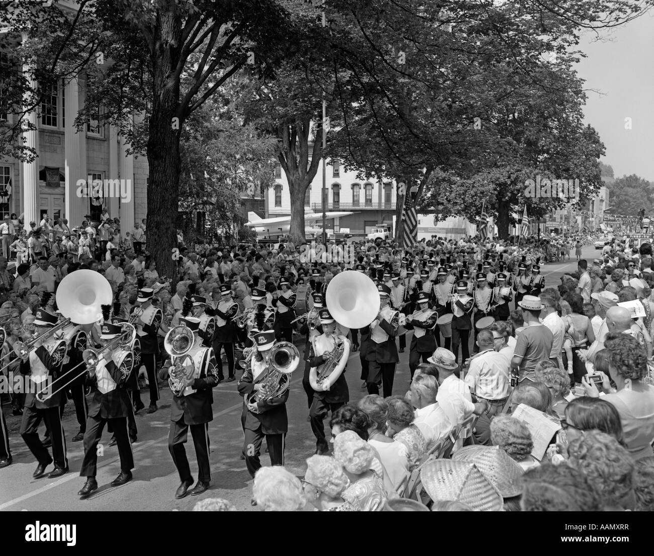 1960s FOURTH OF JULY MAIN STREET PARADE WITH MARCHING BAND Stock Photo