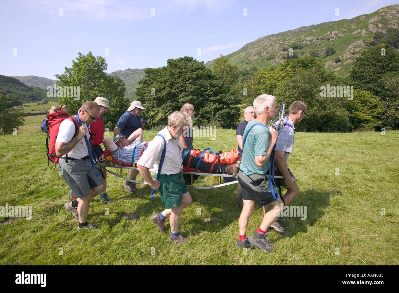 Walking Rescuers Mountain Rescue team stretcher an injured walker off the hill Grasmere ...