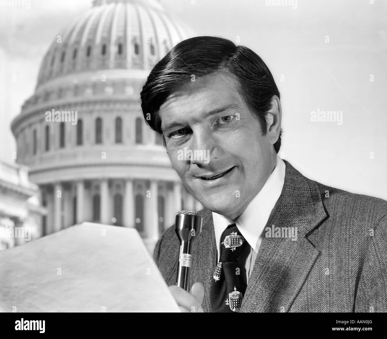 1970s MAN REPORTER WITH MICROPHONE STANDING BEFORE CAPITOL DOME Stock Photo