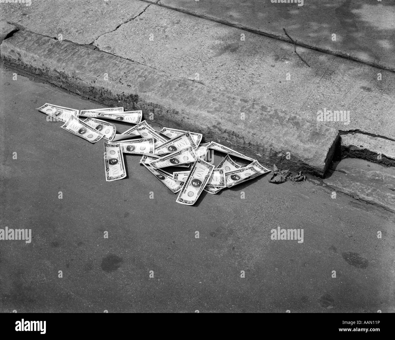 1920s 1930s MONEY IN STREET GUTTER Stock Photo