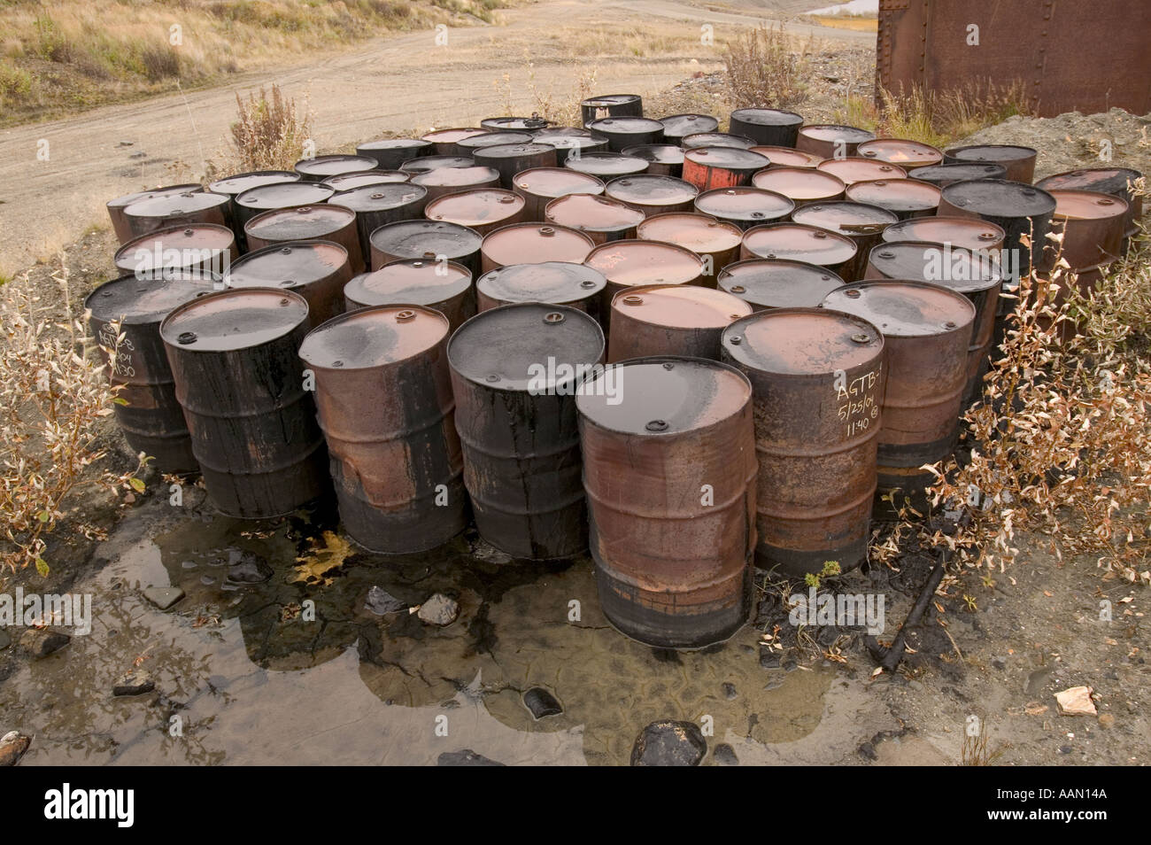 Waste oil barrels abandoned on the Tundra at Nome alaska Stock Photo