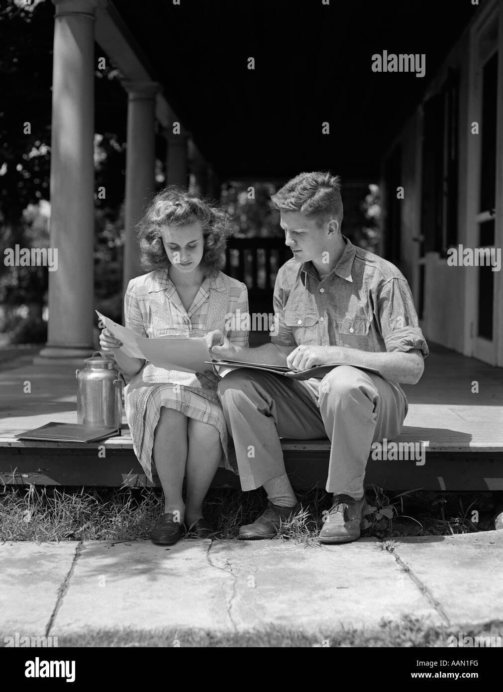 1940s 1950s COUPLE MAN WOMAN SITTING PORCH READING Stock Photo - Alamy