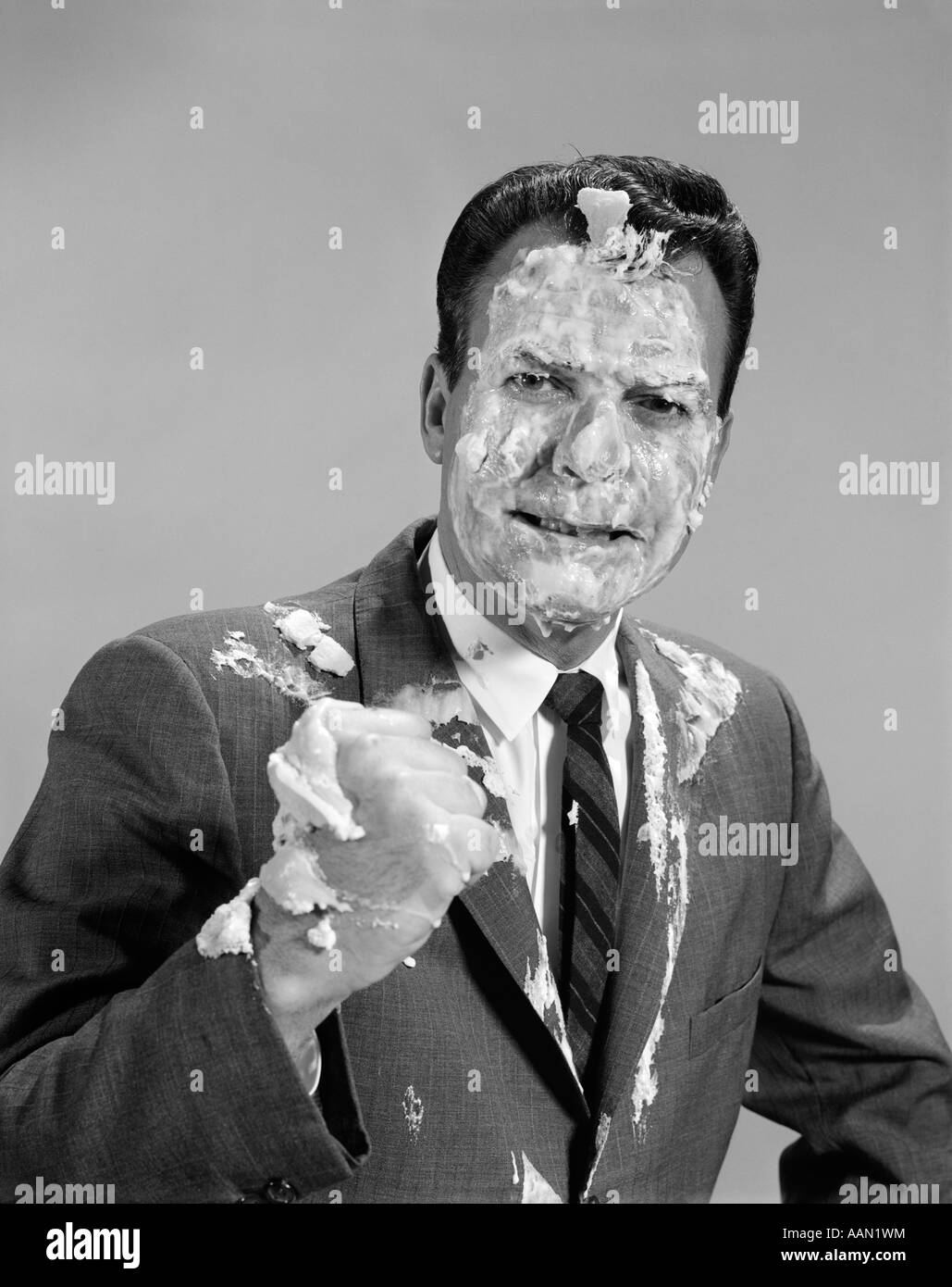 1960s BUSINESSMEN PORTRAIT WITH FOAM ICING SMEARED OVER FACE Stock Photo