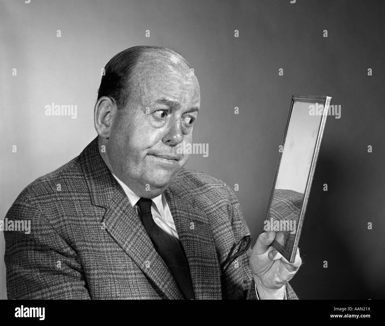 1960s PORTRAIT OF BALDING MAN LOOKING INTO MIRROR Stock Photo
