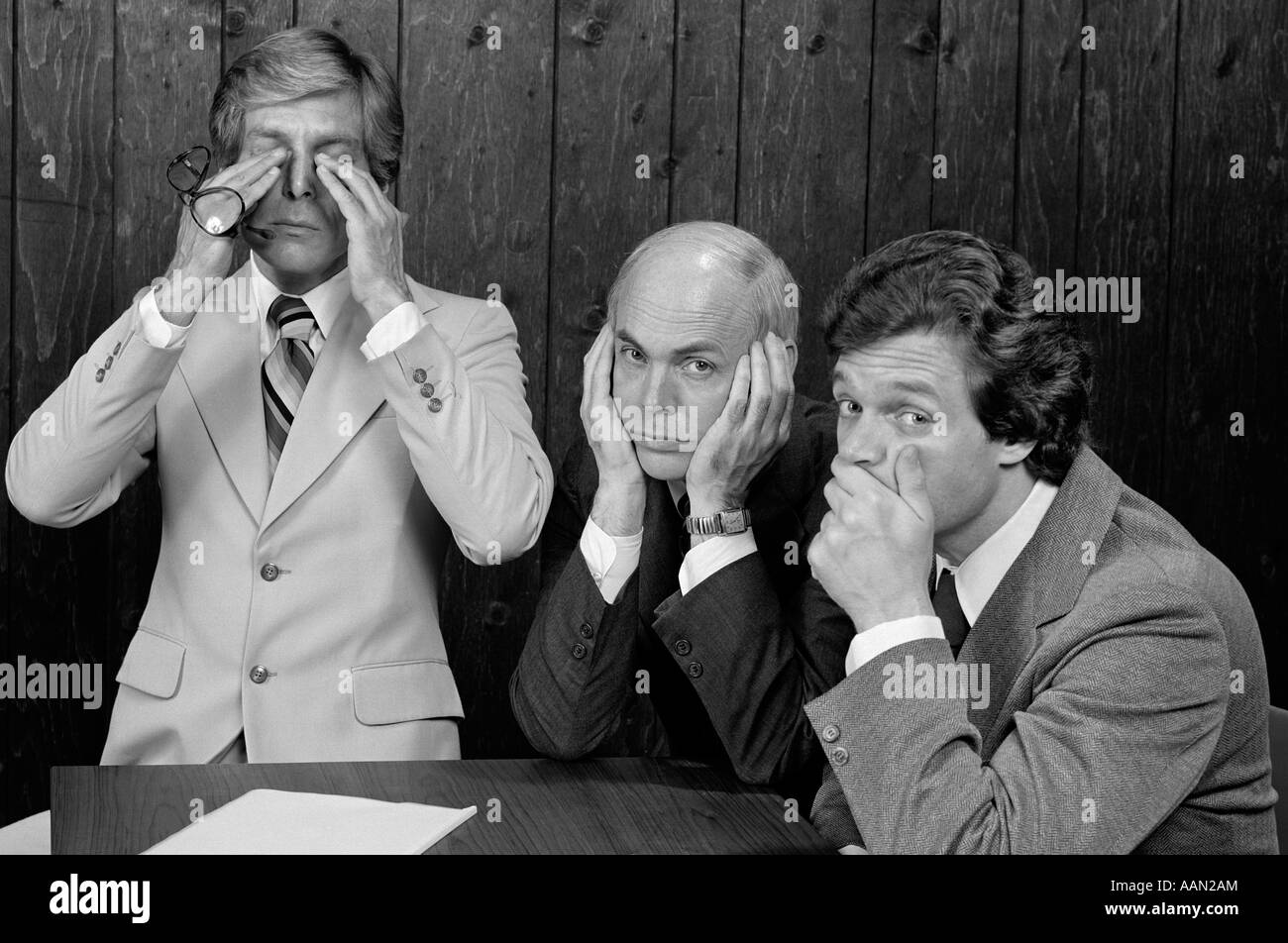 1970s COMMITTEE OF THREE BUSINESSMEN SYMBOLIC HAND GESTURES SEE NO EVIL HEAR NO EVIL SPEAK NO EVIL LOOKING AT CAMERA Stock Photo