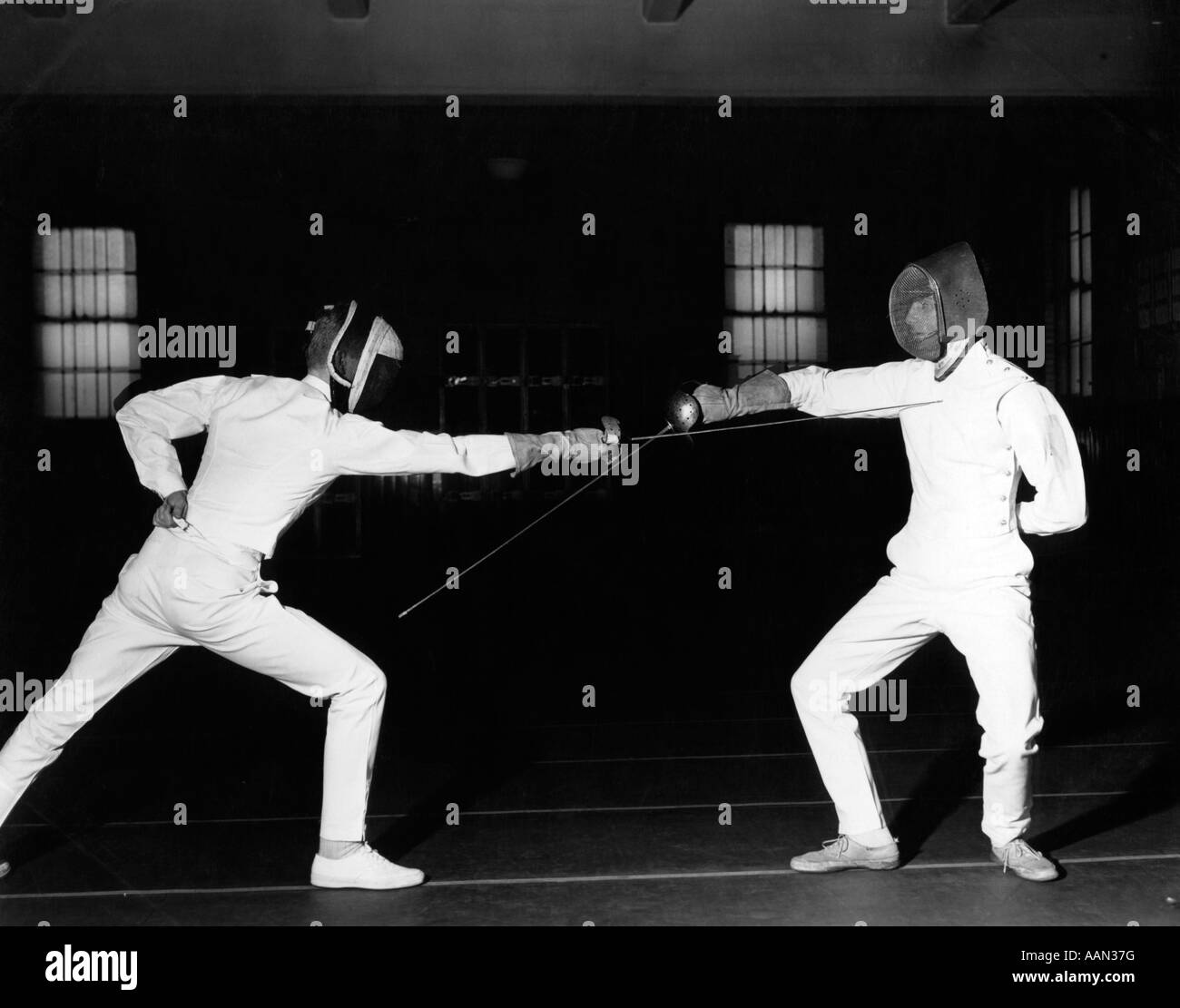 1940s 1950s TWO FENCERS FENCING BOTH ARE WEARING WHITE UNIFORMS AND