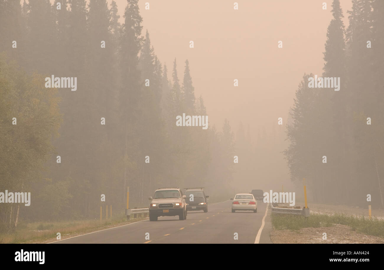 cars coming in smoke of forest fires Fairbanks alaska, caused by the hottest summer on record in 2004 due to global warming Stock Photo