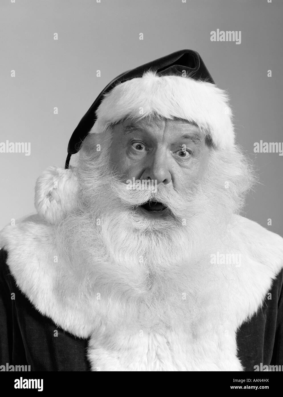 1960s SANTA CLAUS PORTRAIT LOOKING AT CAMERA SURPRISED FACIAL EXPRESSION WHITE BEARD MUSTACHE FUR TRIMMED SUIT Stock Photo