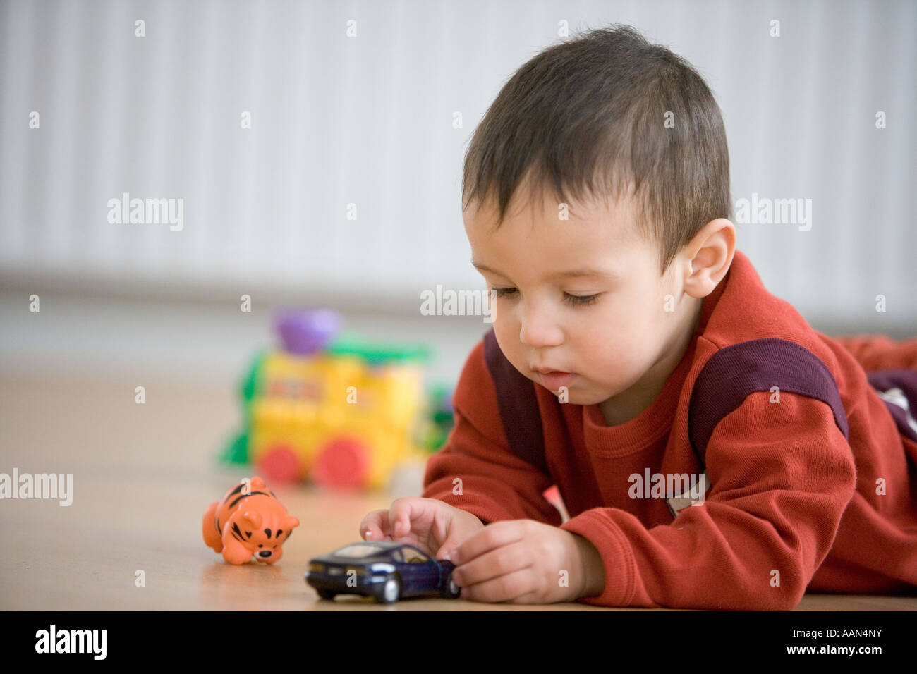 Little boy playing with toy car Stock Photo - Alamy