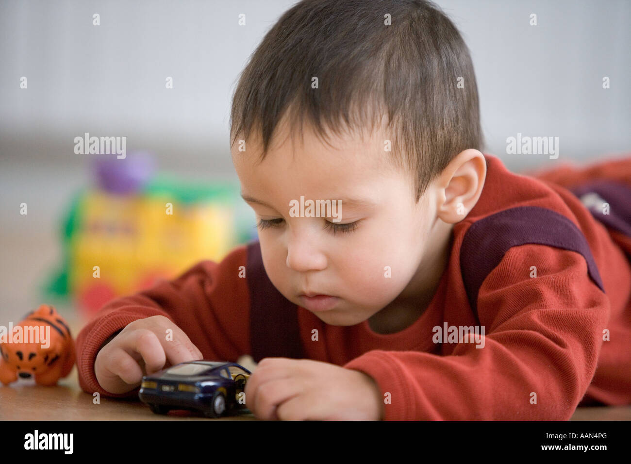 Little boy playing with toy car Stock Photo - Alamy