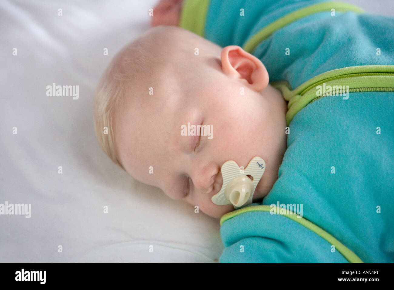 Sleeping baby with comforter Stock Photo Alamy