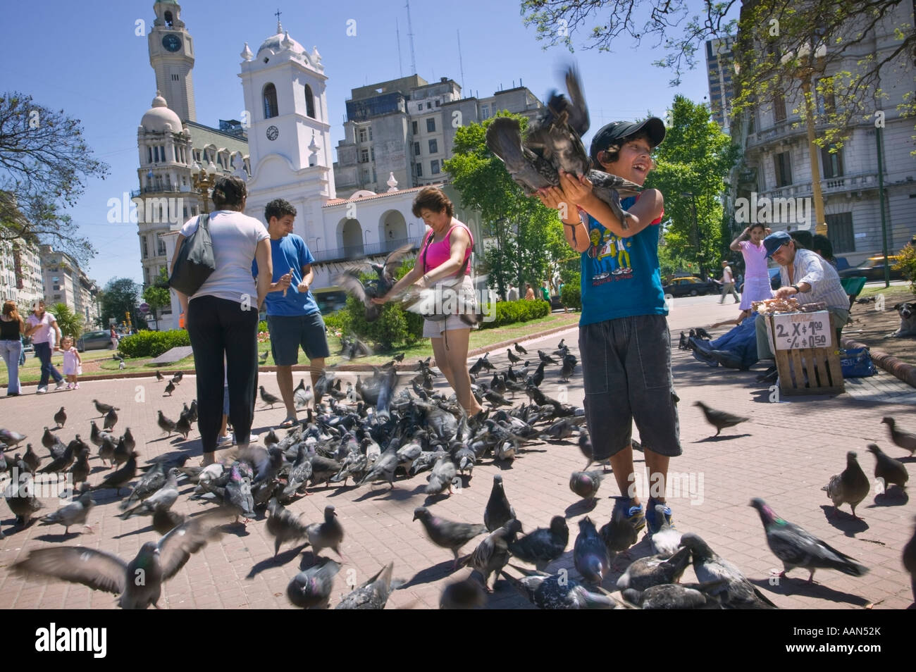 Feeding the pigeons in Plaza de Mayo. Stock Photo