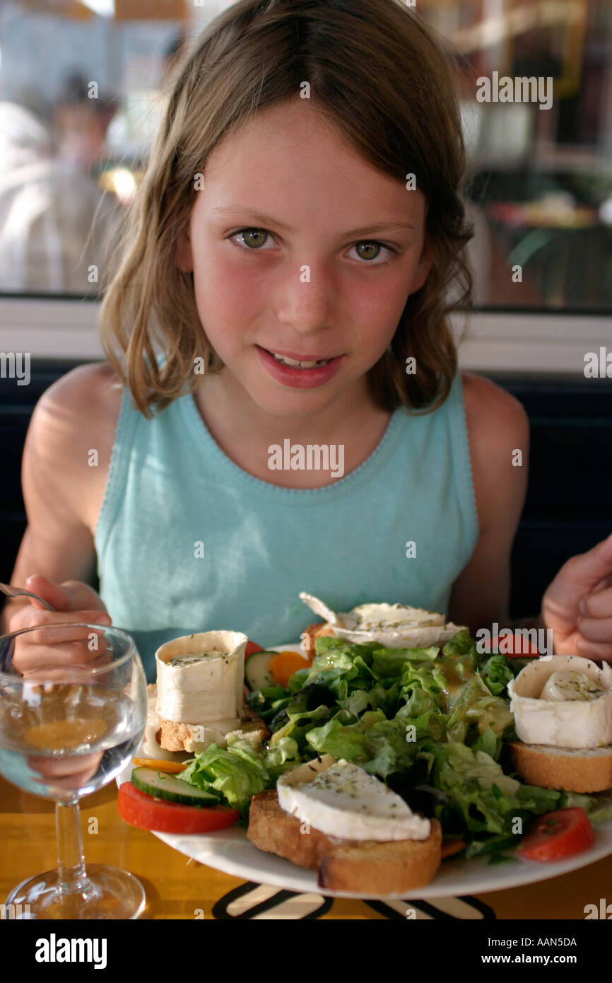 Nine year old girl eats main course at small french restaurant lacanau ocean medoc gironde france Stock Photo