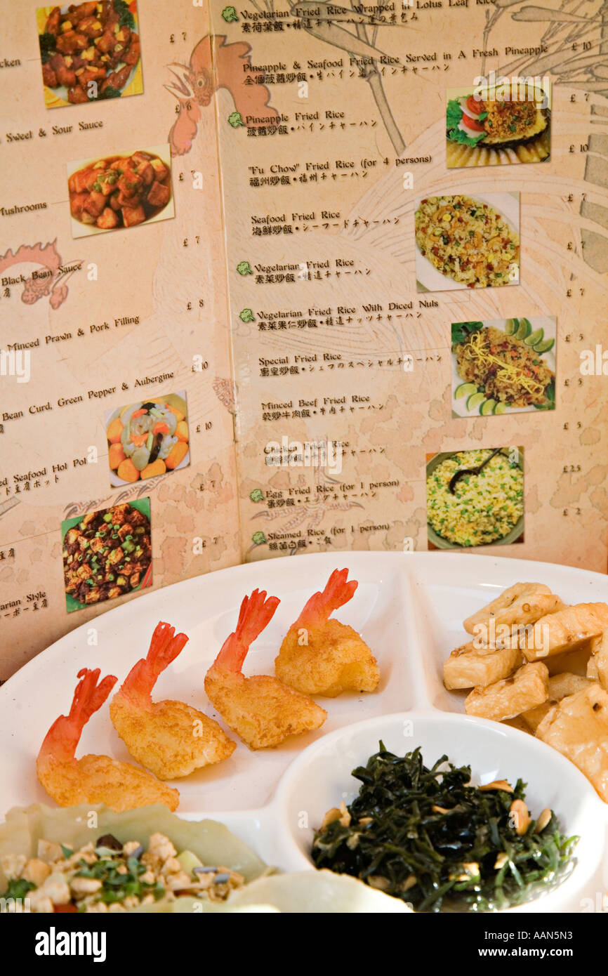 Bilingual Chinese English menu with food on plates in restaurant Cardiff Bay Wales UK Stock Photo