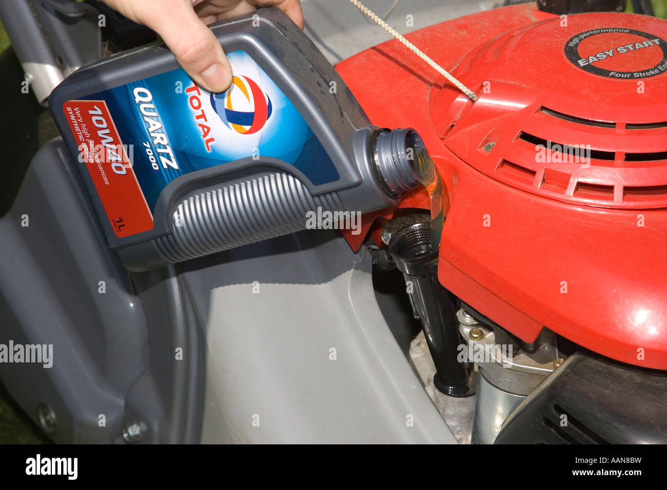 adding oil to lawnmower engine Stock Photo Alamy