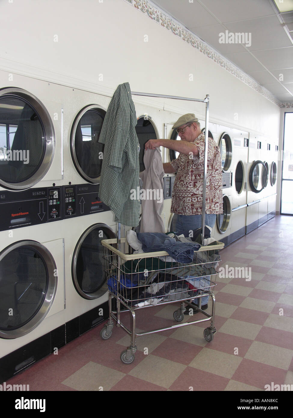 Man inside dryer laundromat clothing hires stock photography and
