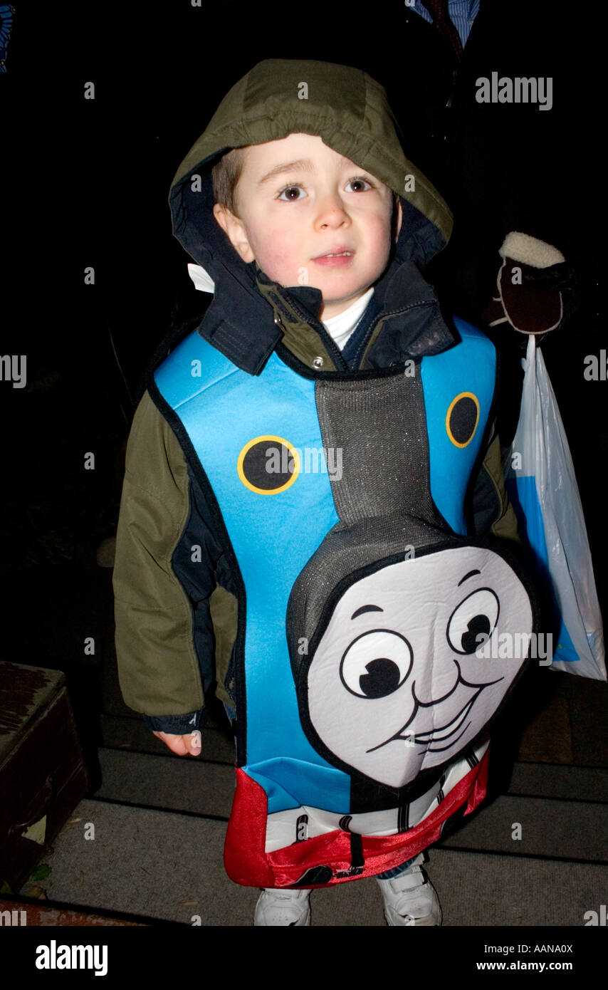 Trick or treater wearing Thomas the Train costume for Halloween.  St Paul Minnesota USA Stock Photo