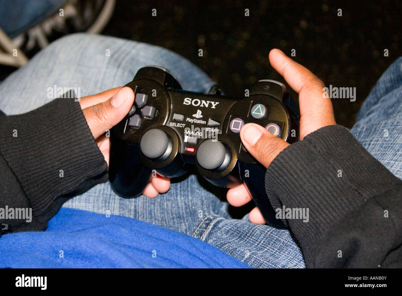 Controller held for playing Sony Playstation in after school study program.  St Paul Minnesota USA Stock Photo