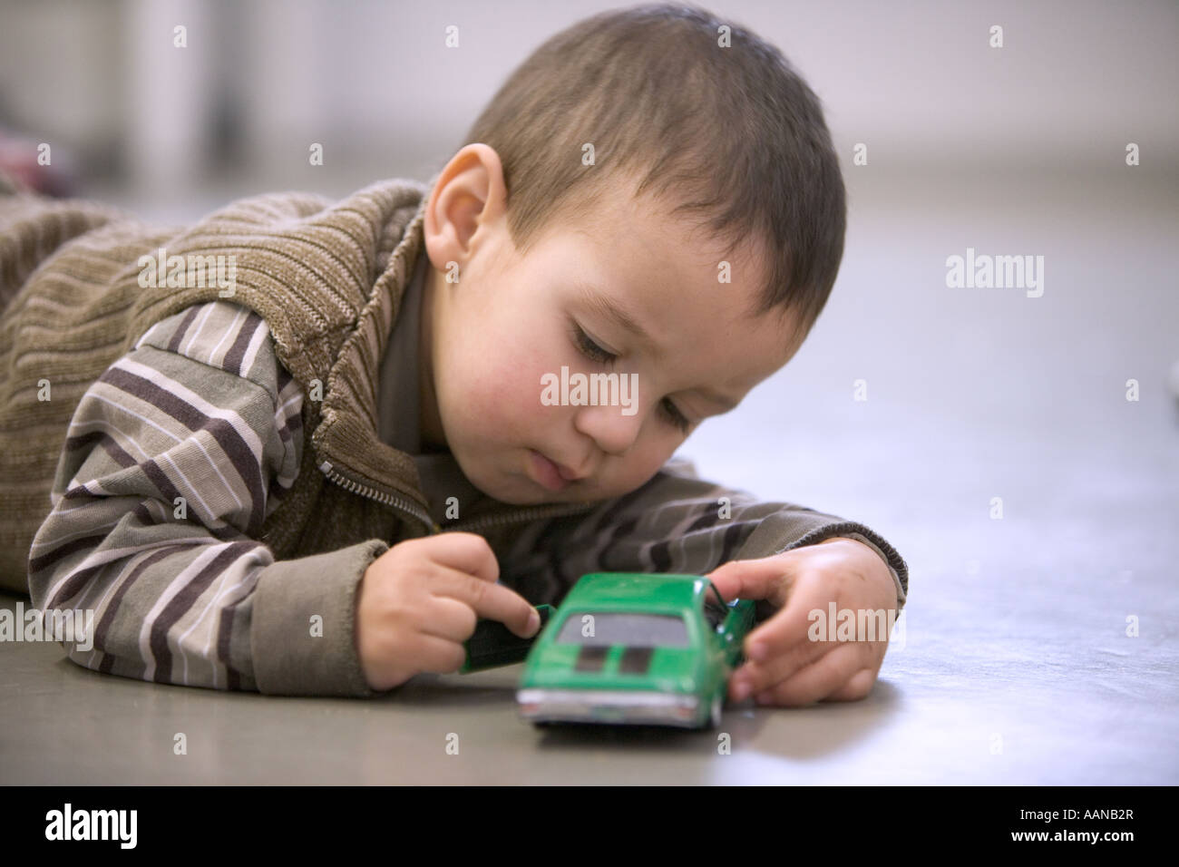 Little boy playing with toy car Stock Photo - Alamy