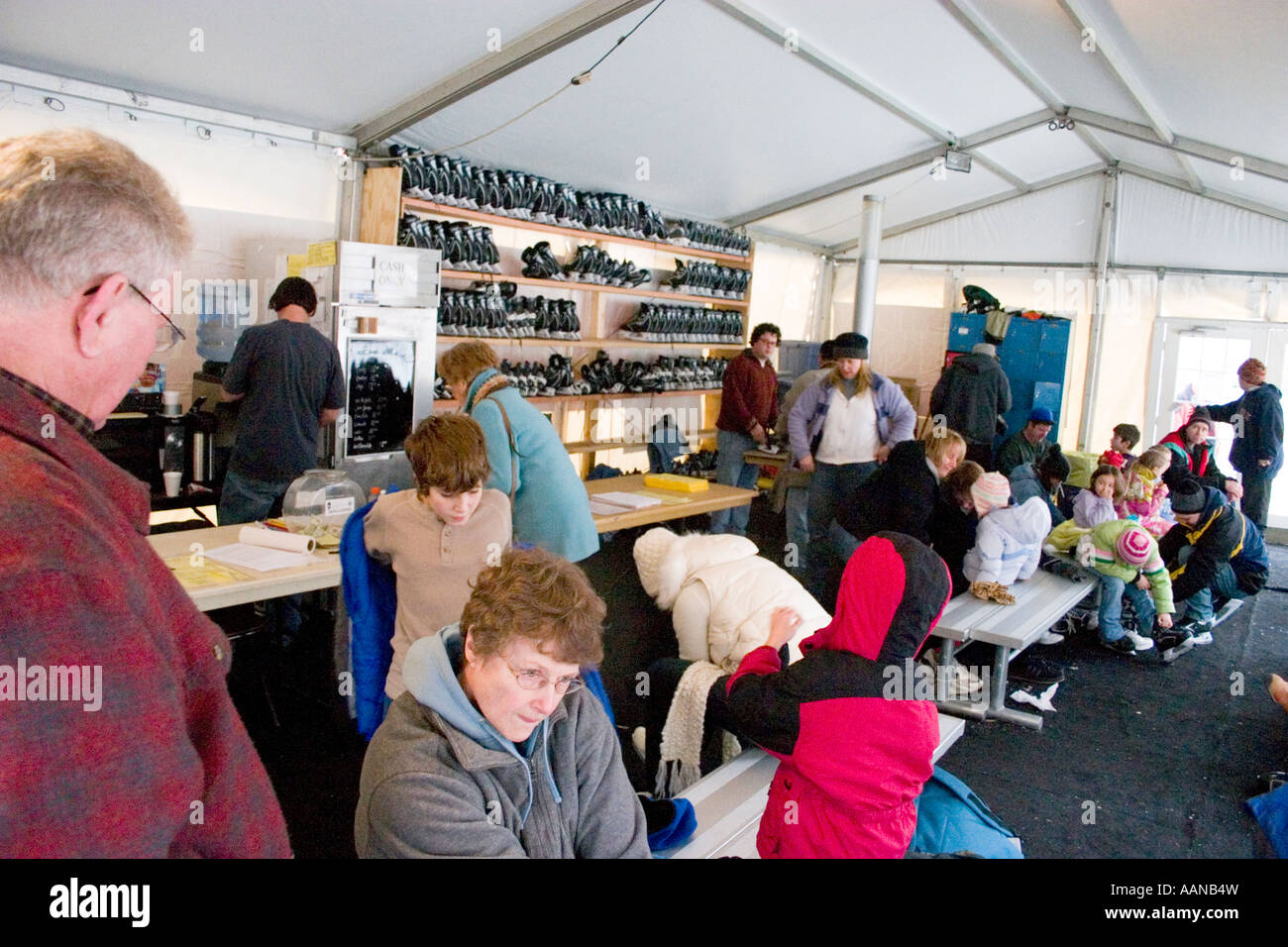 Putting on ice skates in warming house at downtown rink. Wells Fargo