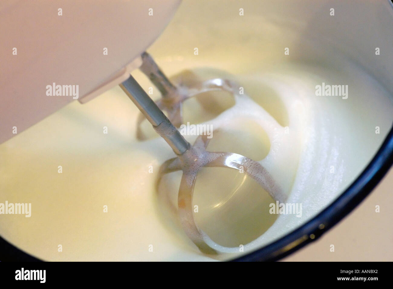 Beaters in a bowl in the process of whipping cream Stock Photo Alamy