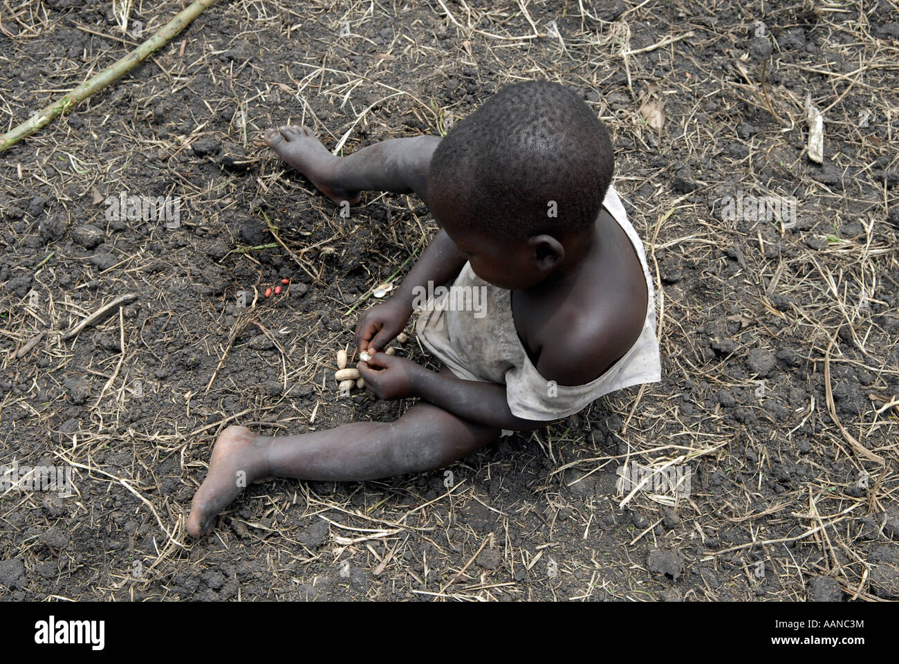 Young boy siting in the ground in an IDP camp in North Kivu province in DR Congo Africa Stock Photo