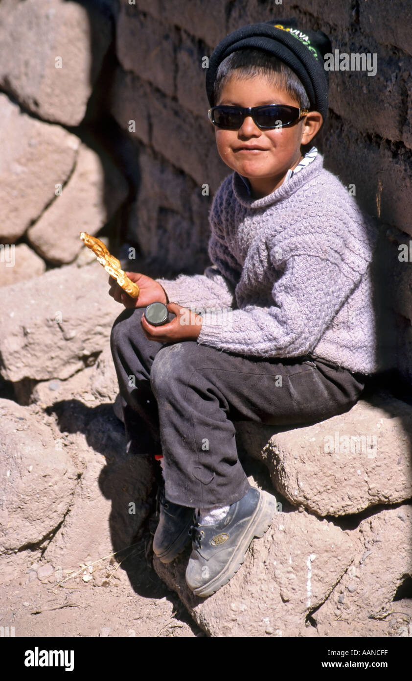 Indian child playing in the street, Pueblo Alota, Altiplano, Bolivia Stock Photo