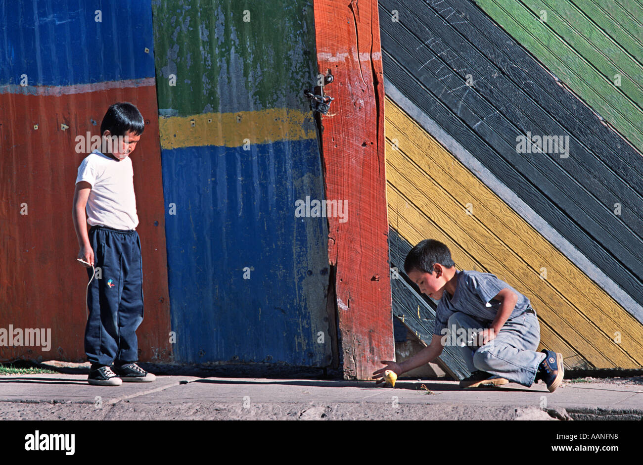 Peruvian boys playing with spinning tops in the street Huaraz Northern Peru South America Stock Photo