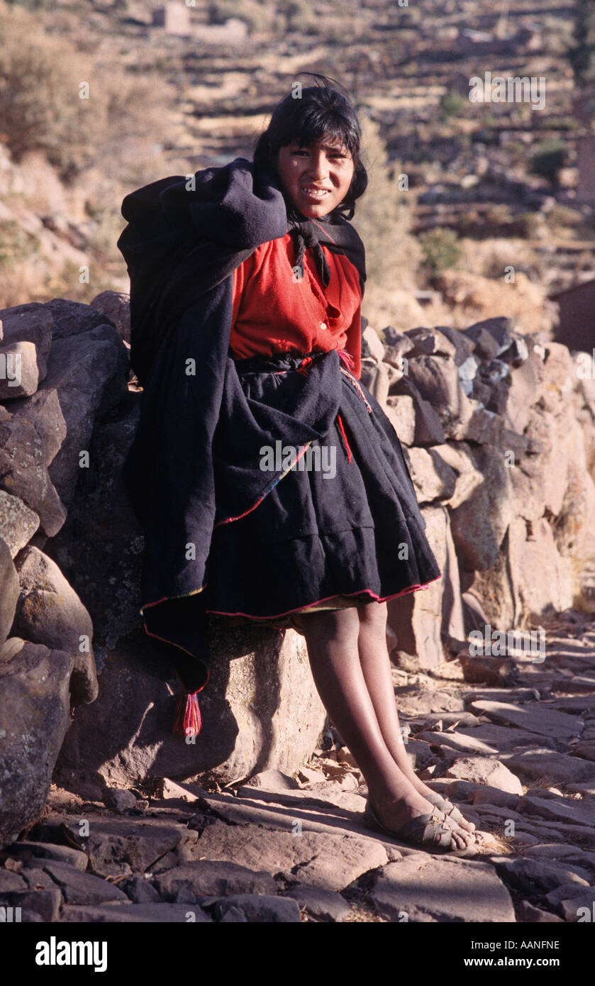 Young woman from Taquile in local style tribal dress Taquile island Lake Titicaca Peru Stock Photo