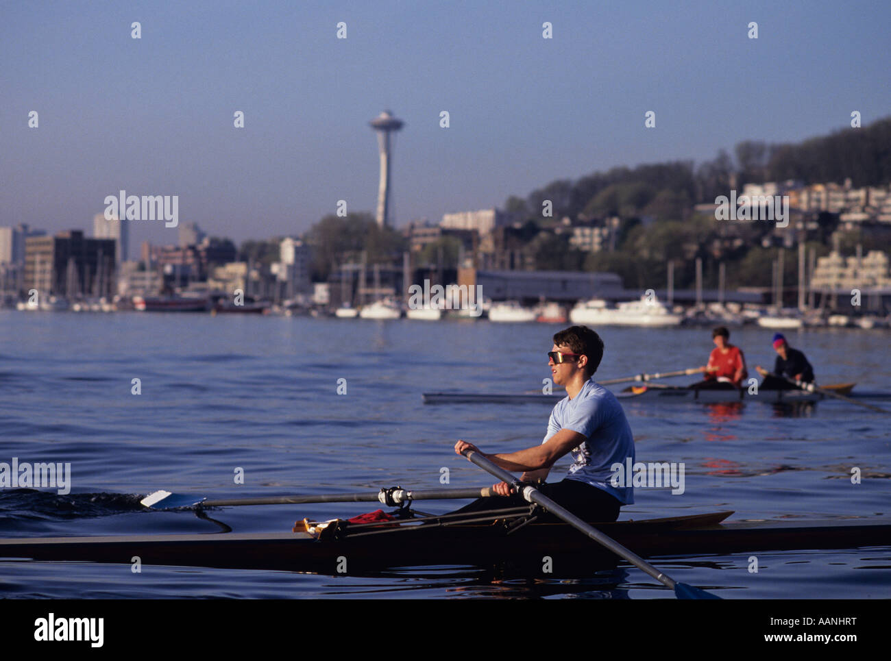 Lake Union with rowers practicing with Space needle in background, summer day Seattle, Washington State, USA Stock Photo