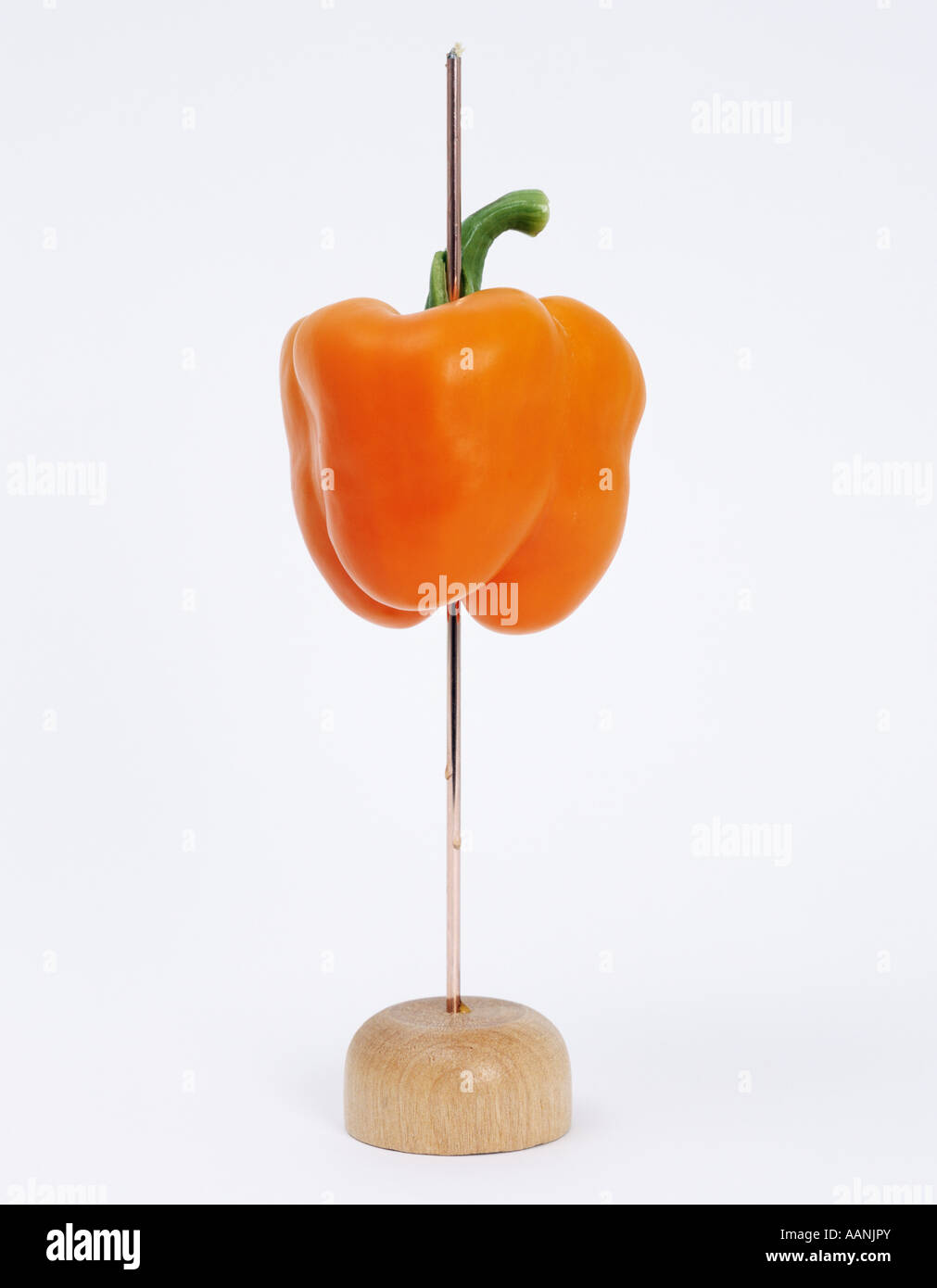 Orange Pepper on wire receipt spike on white background Stock Photo