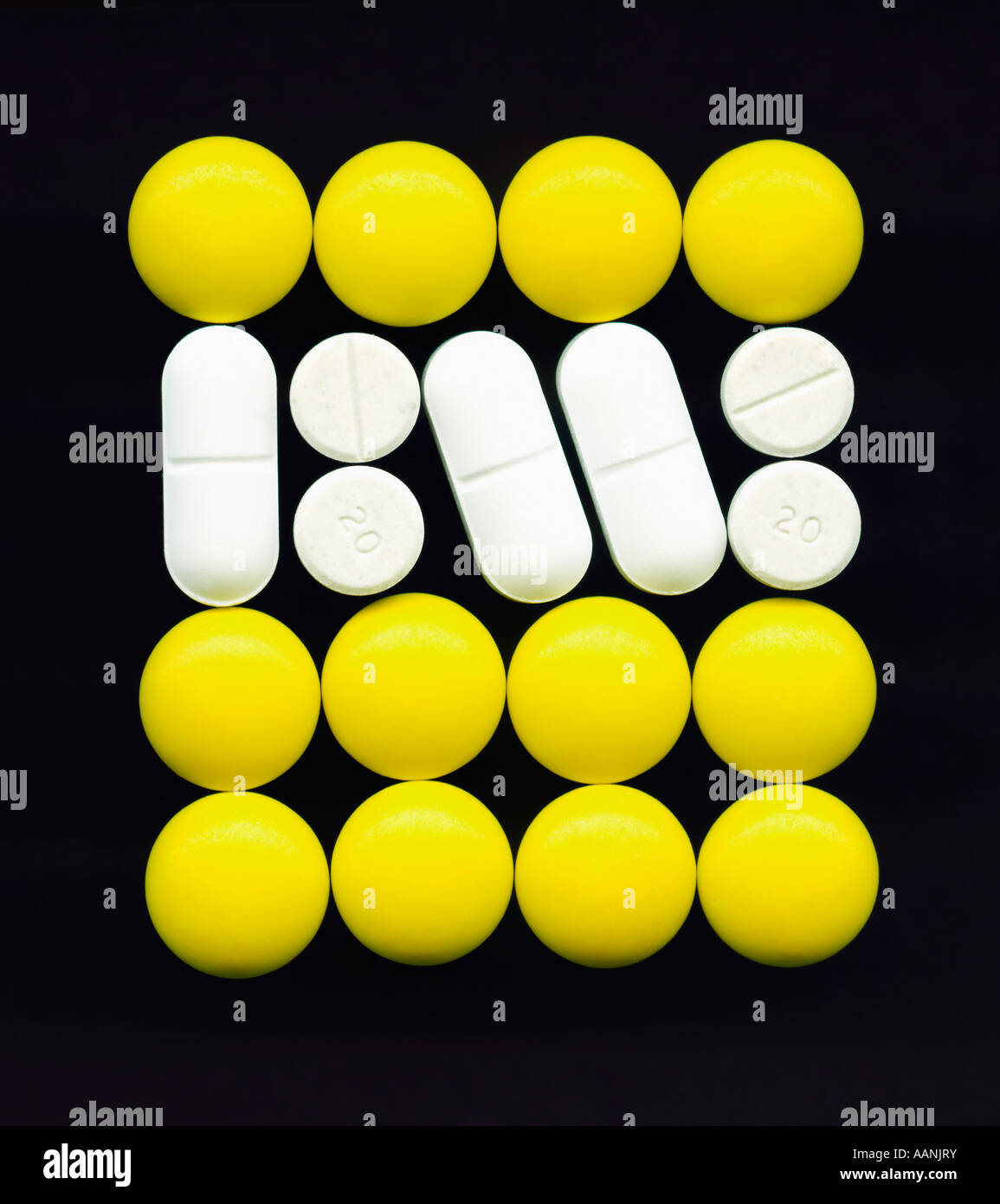Square of yellow and white pills on black background Stock Photo