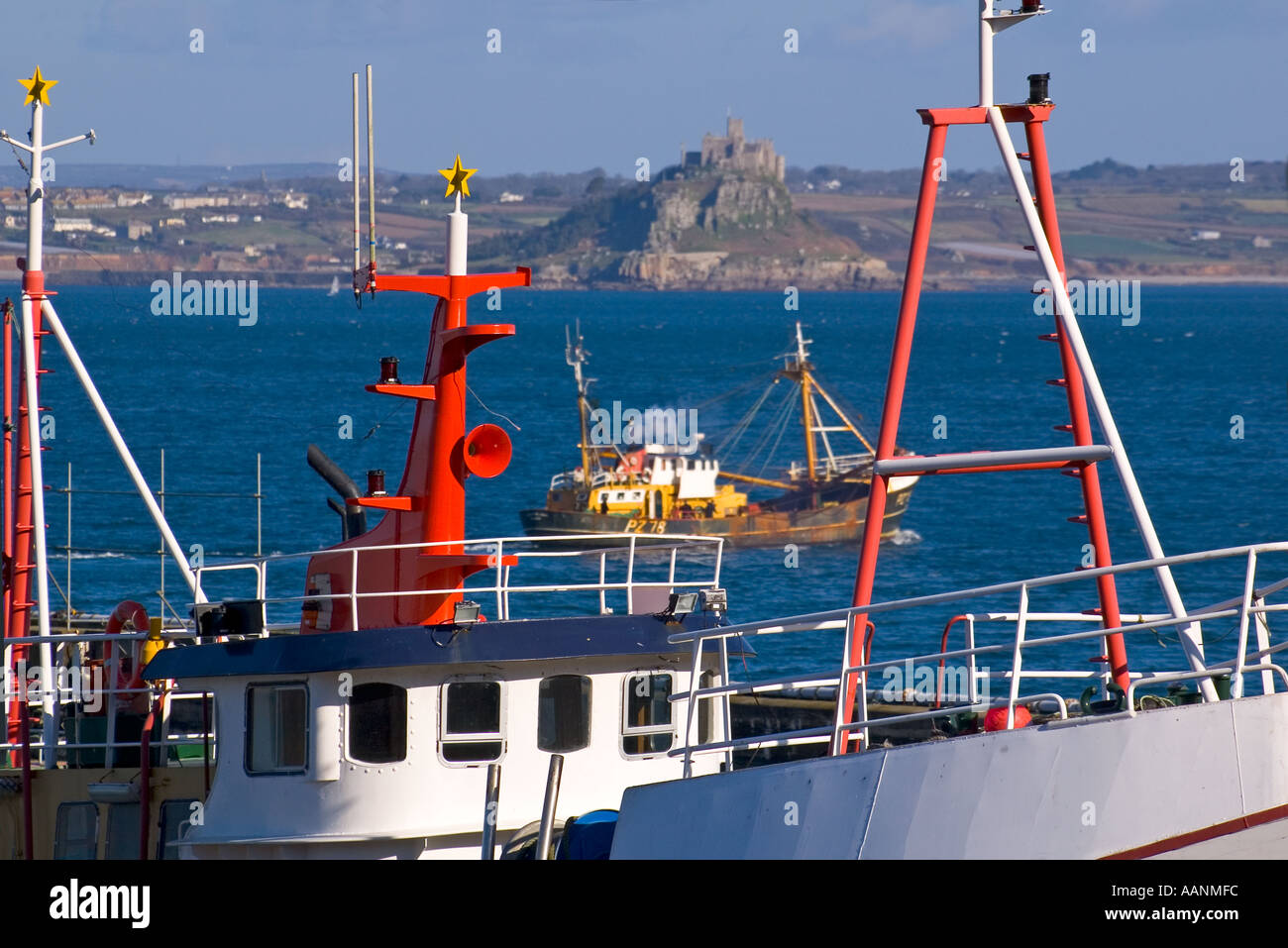 UK GB England Cornwall fishing boats in Newlyn with St Michael s Mount Stock Photo