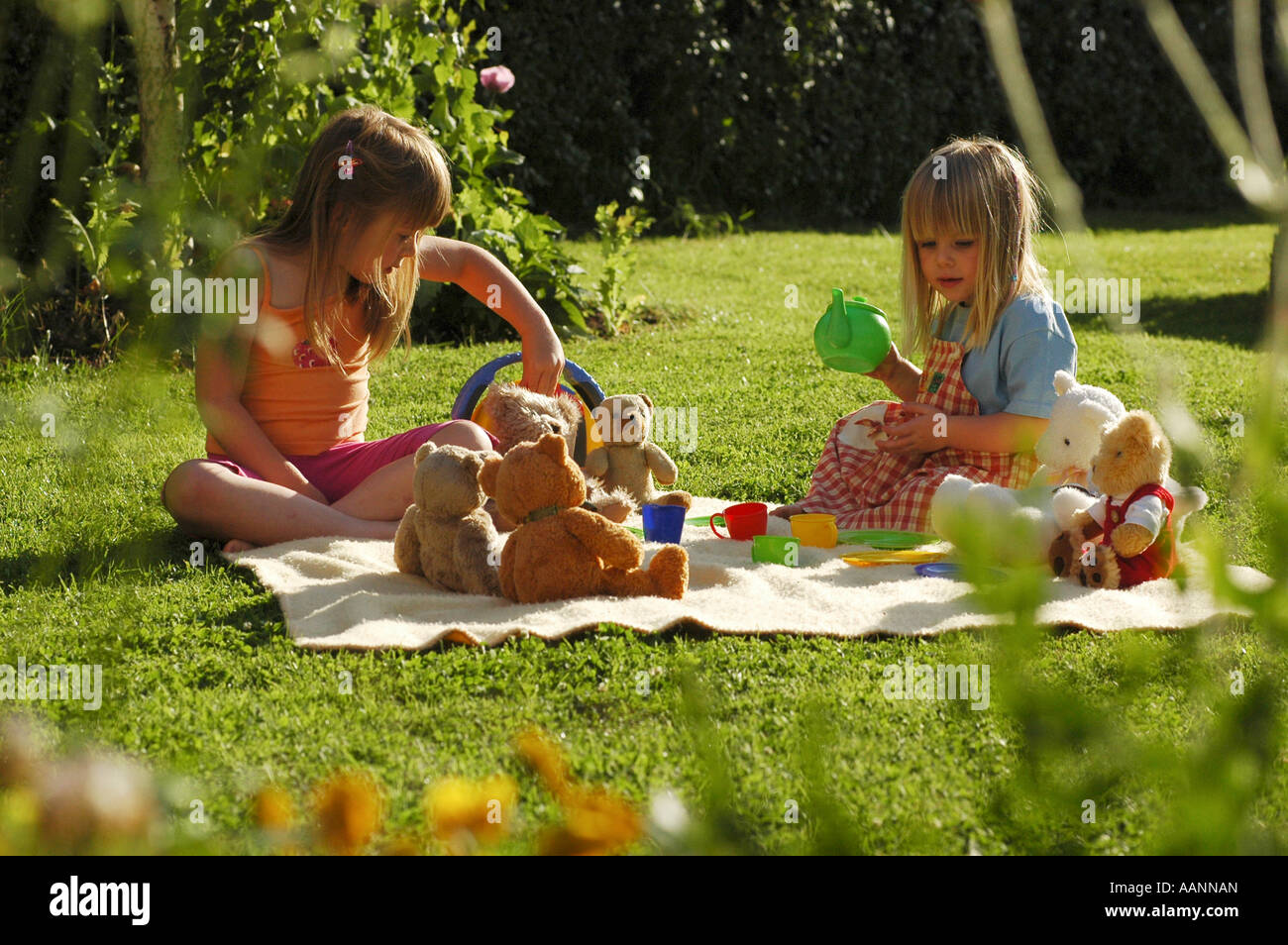 Two young girls have a tea party in garden Stock Photo - Alamy