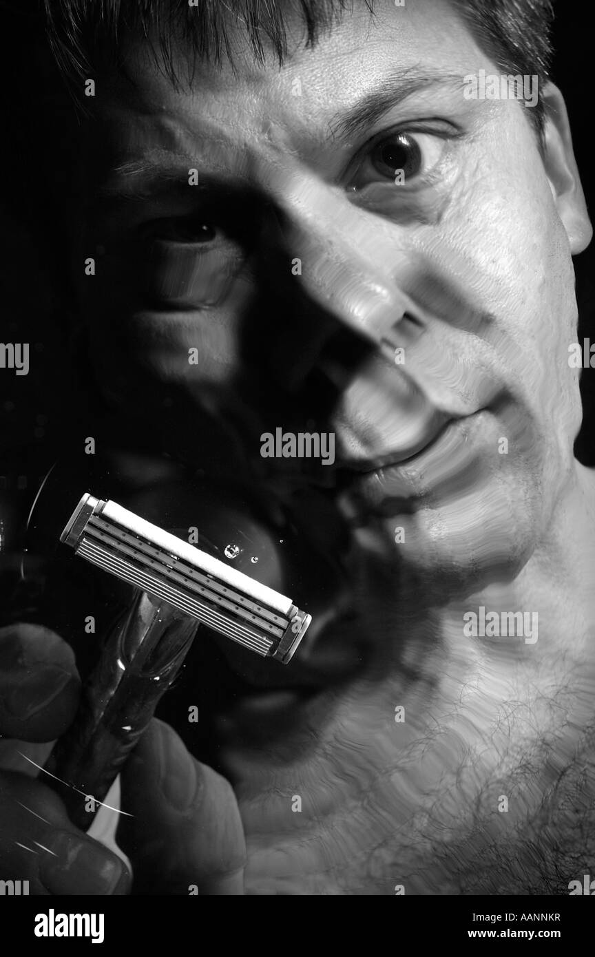 Man shaving, viewed through rippled water. Stock Photo