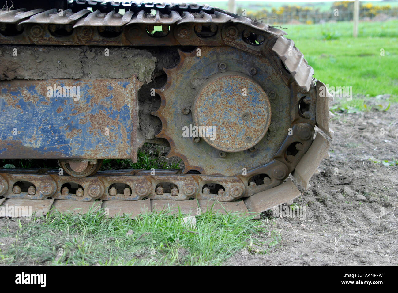 Rusted and bent caterpillar track on construction equipment Stock Photo