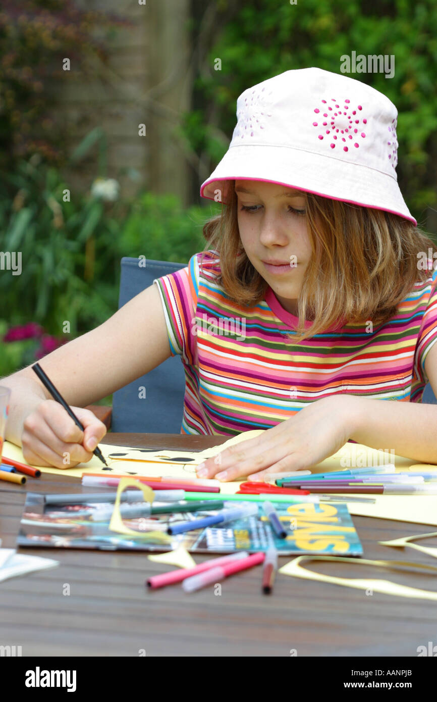 https://c8.alamy.com/comp/AANPJB/young-girl-aged-12-years-doing-art-work-in-summer-garden-wearing-pink-AANPJB.jpg