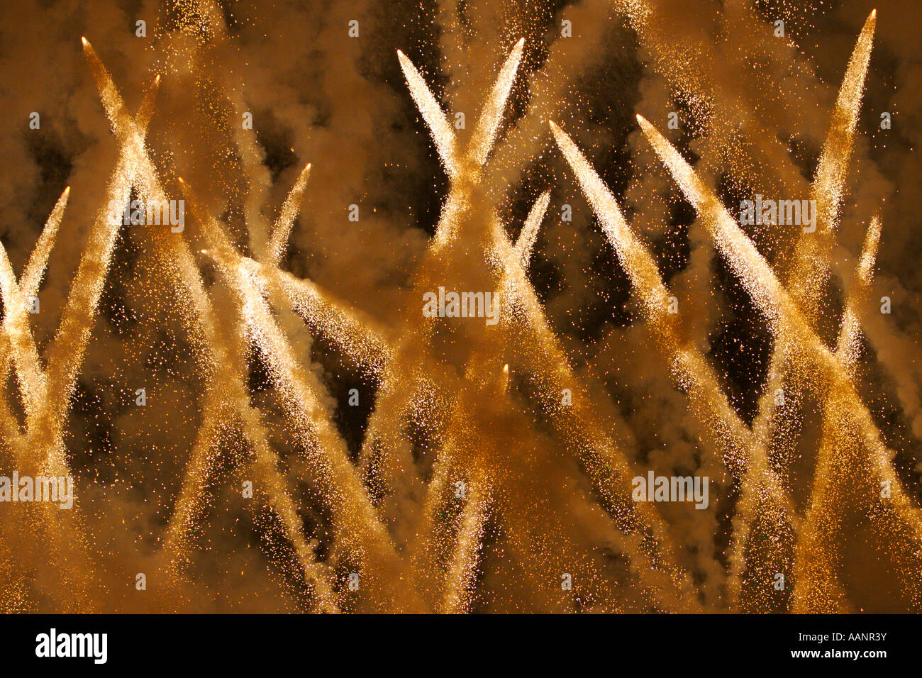 Crisscrossing fireworks during a pyrotechnics show. Stock Photo
