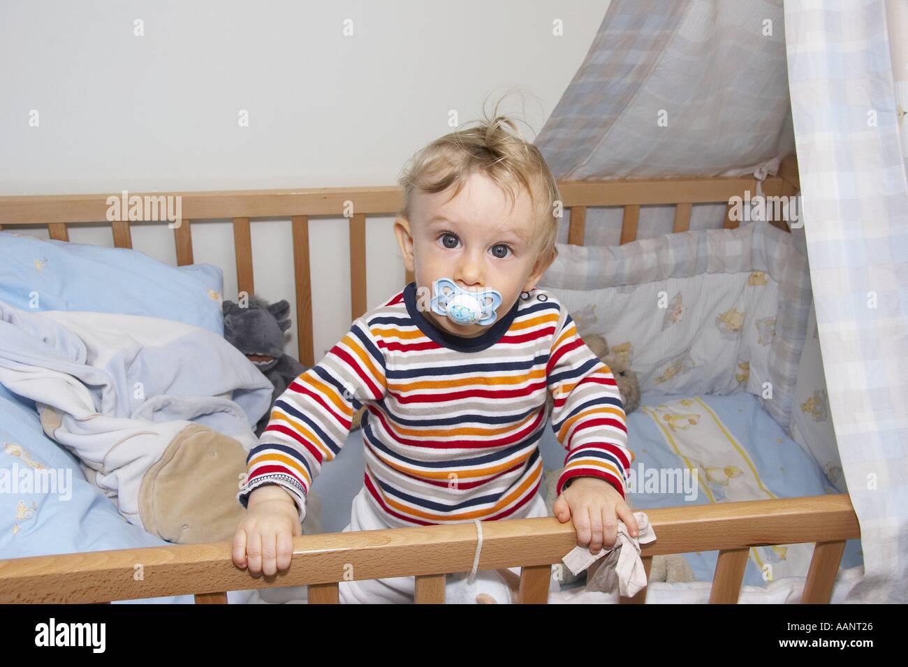 baby at edge of crib Stock Photo