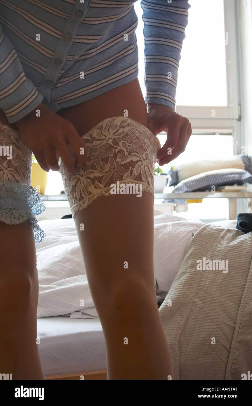 young woman with stockings / garter visible Stock Photo - Alamy